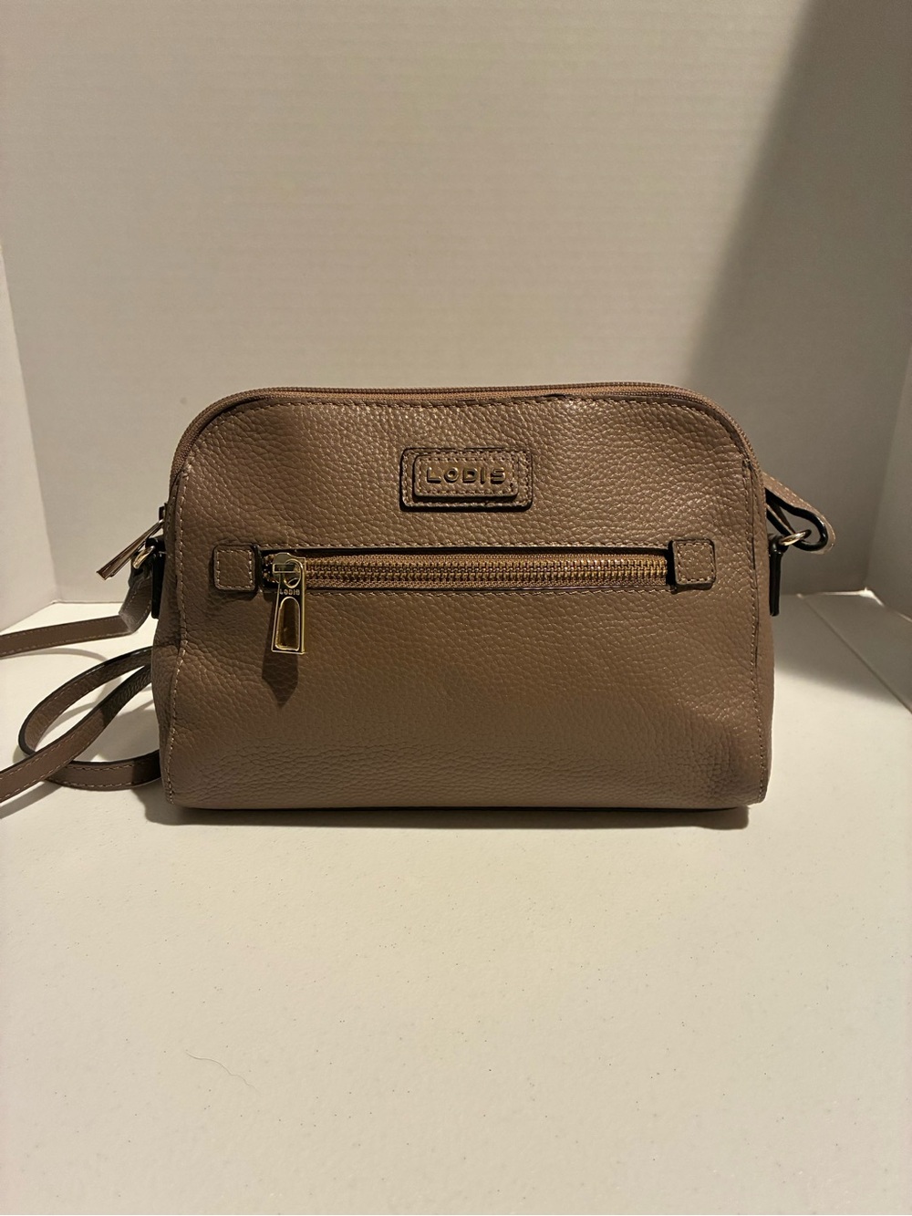 Lodis Pebbled Taupe Leather Crossbody with Gold Hardware. Adjustable strap.